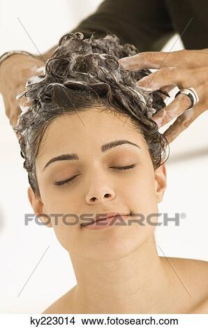 Woman having hair washed by a hairdresser View Large Photo Image Picture - Woman having hair washed by a hairdresser. Fotosearch
