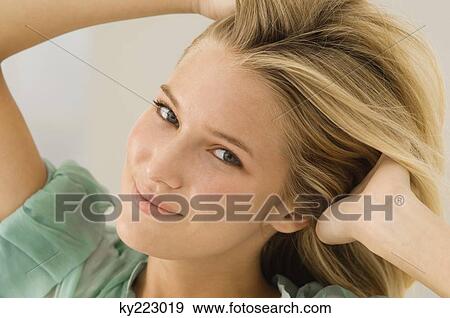 Woman with her hands in her hair View Large Photo Image Stock Photo - Woman with her hands in her hair. Fotosearch