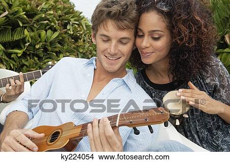 Couple playing musical instruments View Large Photo Image Picture - Couple playing musical instruments. Fotosearch