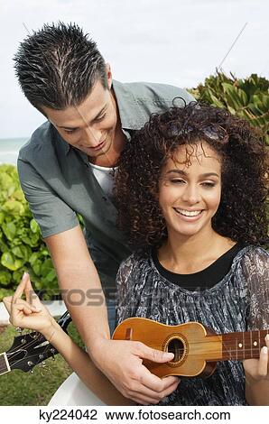 Couple playing ukulele View Large Photo Image Stock Image - Couple playing ukulele. Fotosearch