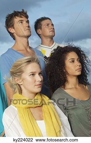 Four friends looking away View Large Photo Image Stock Image - Four friends looking away. Fotosearch