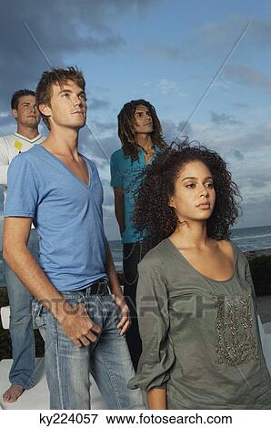 Four friends standing on the beach View Large Photo Image Stock Photo - Four friends standing on the beach. Fotosearch