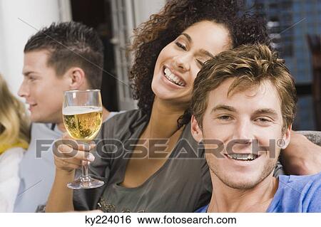 Stock Photograph - Friends enjoying a party. Fotosearch