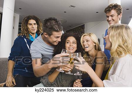 Friends toasting with wine glasses in a party View Large Photo Image Stock Photography - Friends toasting with wine glasses in a party. Fotosearch