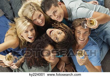 Stock Image - High angle view of friends with wine. Fotosearch