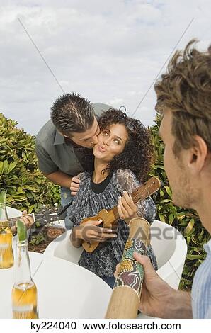 Stock Image - Man kissing a woman. Fotosearch