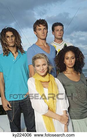 Portrait of five friends standing on the beach View Large Photo Image Stock Photograph - Portrait of five friends standing on the beach. Fotosearch