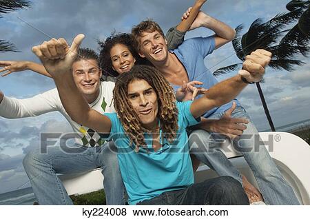 Stock Photo - Portrait of four friends looking cheerful. Fotosearch