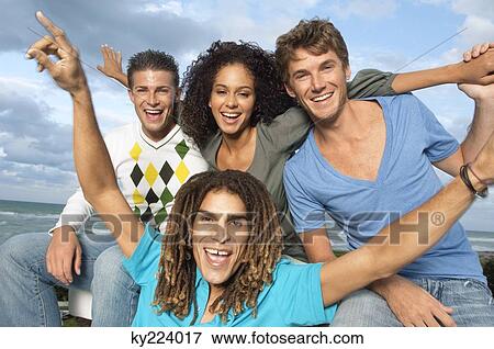 Stock Photo - Portrait of four friends looking cheerful. Fotosearch