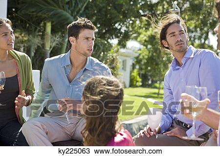 Stock Image - Five friends enjoying drinks at a party. Fotosearch