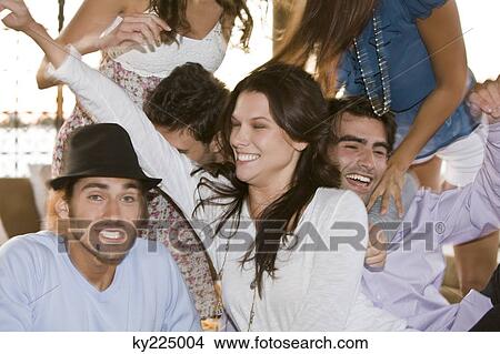 Picture - Group of friends enjoying at a party. Fotosearch