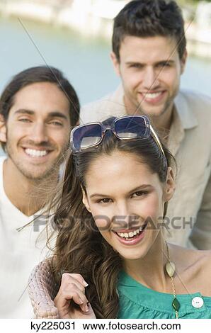 Stock Image - Portrait of three friends smiling. Fotosearch