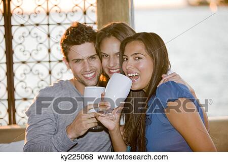 Stock Photo - Three friends enjoying drinks. Fotosearch