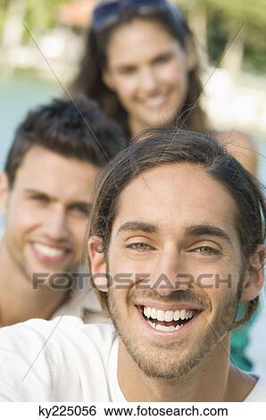 Stock Photograph - Three friends smiling. Fotosearch