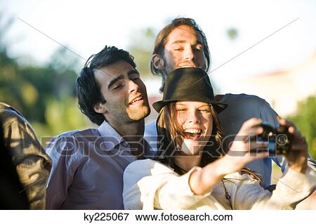 Stock Photo - Three friends taking picture of themselves. Fotosearch