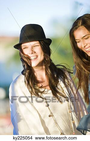 Two women smiling together View Large Photo Image Picture - Two women smiling together. Fotosearch