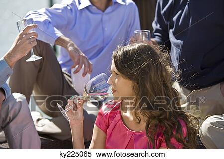 Woman enjoying drinks with her friends at a party View Large Photo Image Stock Photography - Woman enjoying drinks with her friends at a party. Fotosearch