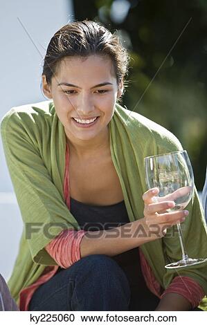 Stock Image - Woman holding a glass. Fotosearch