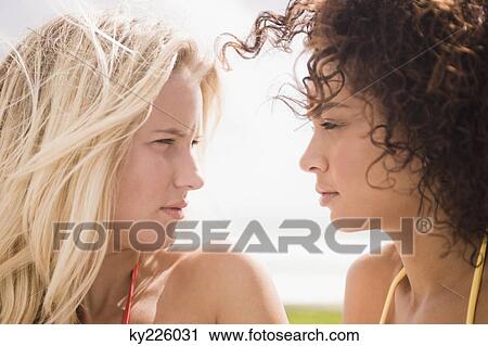 Close-up of two women looking at each other View Large Photo Image Stock Image - Close-up of two women looking at each other. Fotosearch