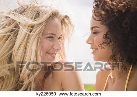 Close-up of two women smiling View Large Photo Image Stock Image - Close-up of two women smiling. Fotosearch