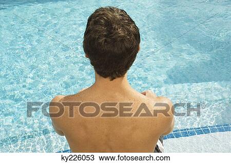 High angle view of a man at the poolside View Large Photo Image Stock Image - High angle view of a man at the poolside. Fotosearch