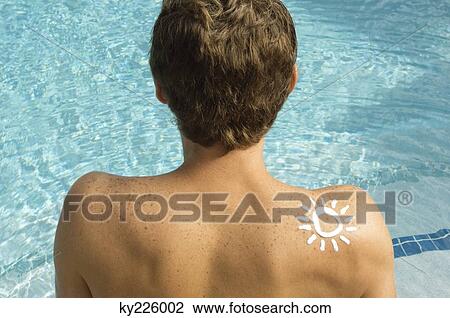Man with sun shape on his shoulder at the poolside View Large Photo Image Stock Image - Man with sun shape on his shoulder at the poolside. Fotosearch