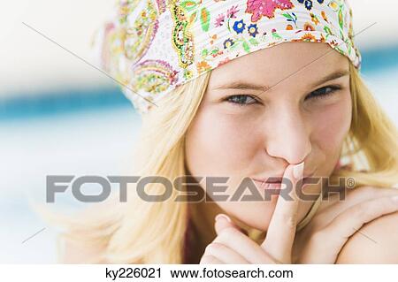 Portrait of a woman with finger on lips View Large Photo Image Stock Image - Portrait of a woman with finger on lips. Fotosearch