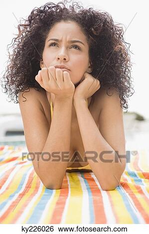 Woman day dreaming at the poolside View Large Photo Image Stock Photograph - Woman day dreaming at the poolside. Fotosearch