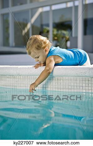 Baby boy playing with water View Large Photo Image Stock Photo - Baby boy playing with water. Fotosearch