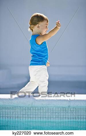 Baby boy walking at the poolside View Large Photo Image Stock Image - Baby boy walking at the poolside. Fotosearch