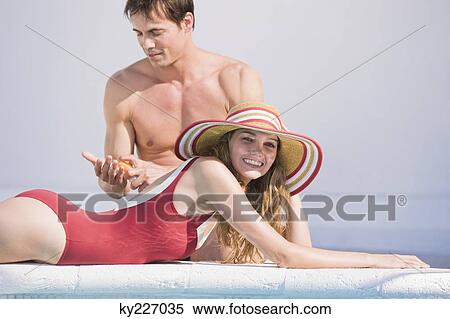 Couple at the poolside View Large Photo Image Stock Photography - Couple at the poolside. Fotosearch