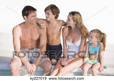Family sitting at the poolside and smiling View Large Photo Image Stock Photo - Family sitting at the poolside and smiling. Fotosearch