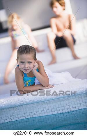Portrait of a girl lying at the poolside and smiling View Large Photo Image Stock Image - Portrait of a girl lying at the poolside and smiling. Fotosearch