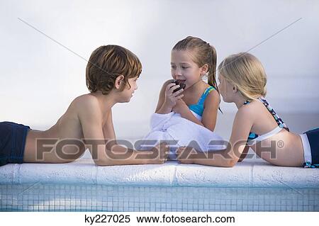 Two girls and a boy at the poolside View Large Photo Image Stock Photography - Two girls and a boy at the poolside. Fotosearch