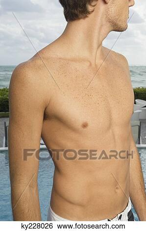 Close-up of a bare chested man on the coast View Large Photo Image Stock Photograph - Close-up of a bare chested man on the coast. Fotosearch