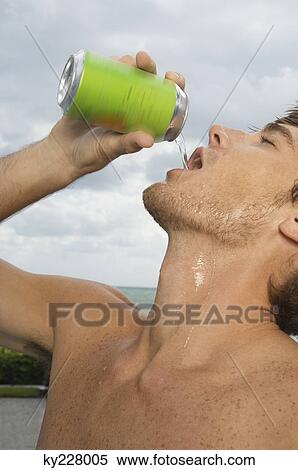 Close-up of a man drinking soda View Large Photo Image Stock Photography - Close-up of a man drinking soda. Fotosearch