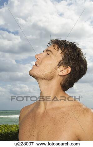 Close-up of a man looking up View Large Photo Image Stock Photo - Close-up of a man looking up. Fotosearch
