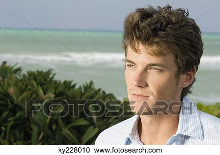 Close-up of a man on the beach View Large Photo Image Stock Image - Close-up of a man on the beach. Fotosearch