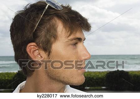 Close-up of a man with sunglasses on his head View Large Photo Image Stock Photo - Close-up of a man with sunglasses on his head. Fotosearch