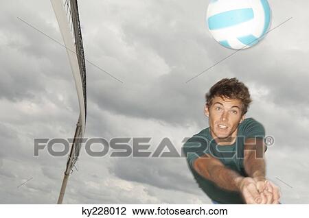 Man playing volleyball on the beach View Large Photo Image Stock Image - Man playing volleyball on the beach. Fotosearch