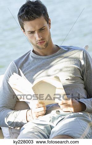 Man reading a book View Large Photo Image Stock Image - Man reading a book. Fotosearch