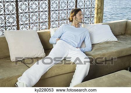 Man resting in a tourist resort View Large Photo Image Stock Image - Man resting in a tourist resort. Fotosearch