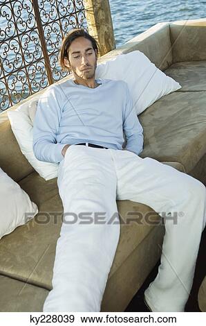 Man resting in a tourist resort View Large Photo Image Stock Photo - Man resting in a tourist resort. Fotosearch