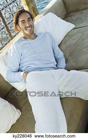 Man resting in a tourist resort View Large Photo Image Stock Photograph - Man resting in a tourist resort. Fotosearch