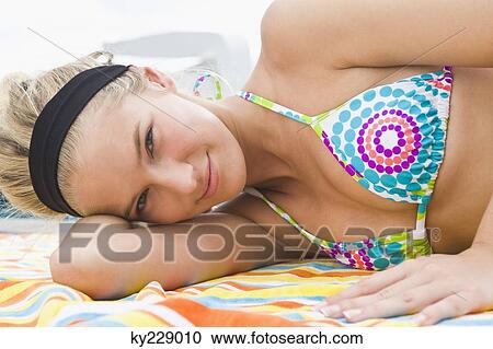 Portrait of a woman smiling at the poolside View Large Photo Image Stock Image - Portrait of a woman smiling at the poolside. Fotosearch