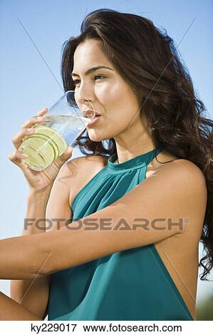 Stock Photo - Woman drinking lemonade. Fotosearch