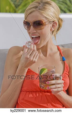 Woman holding a glass of cola View Large Photo Image Stock Image - Woman holding a glass of cola. Fotosearch