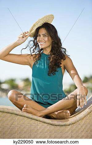 Woman holding a hand fan on her head View Large Photo Image Stock Image - Woman holding a hand fan on her head. Fotosearch