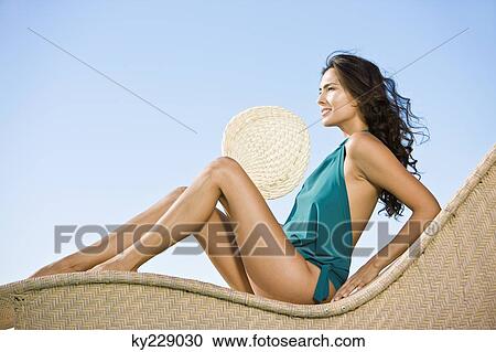 Stock Image - Woman holding a hand fan. Fotosearch