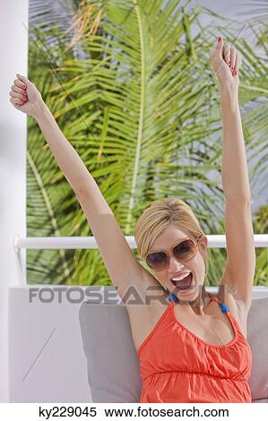 Woman laughing with her arms raised View Large Photo Image Stock Photography - Woman laughing with her arms raised. Fotosearch